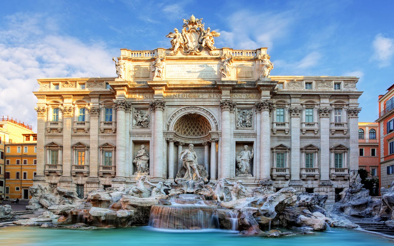 Trevi Fountain in Rome, featuring baroque sculptures and cascading water, part of a golf cart tour.