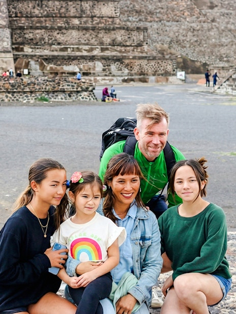 Family posing in front of the Pyramid of the Moon at Teotihuacán during a tour from Mexico City.
