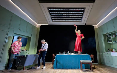 Stage performance of Inter Alia show on Broadway with actors in a kitchen setting.