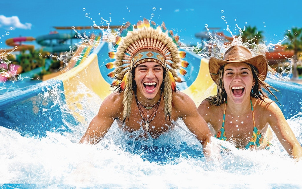 Tourists enjoying a water slide at Western Water Park.