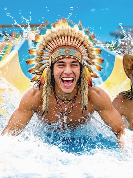 Tourists enjoying a water slide at Western Water Park.