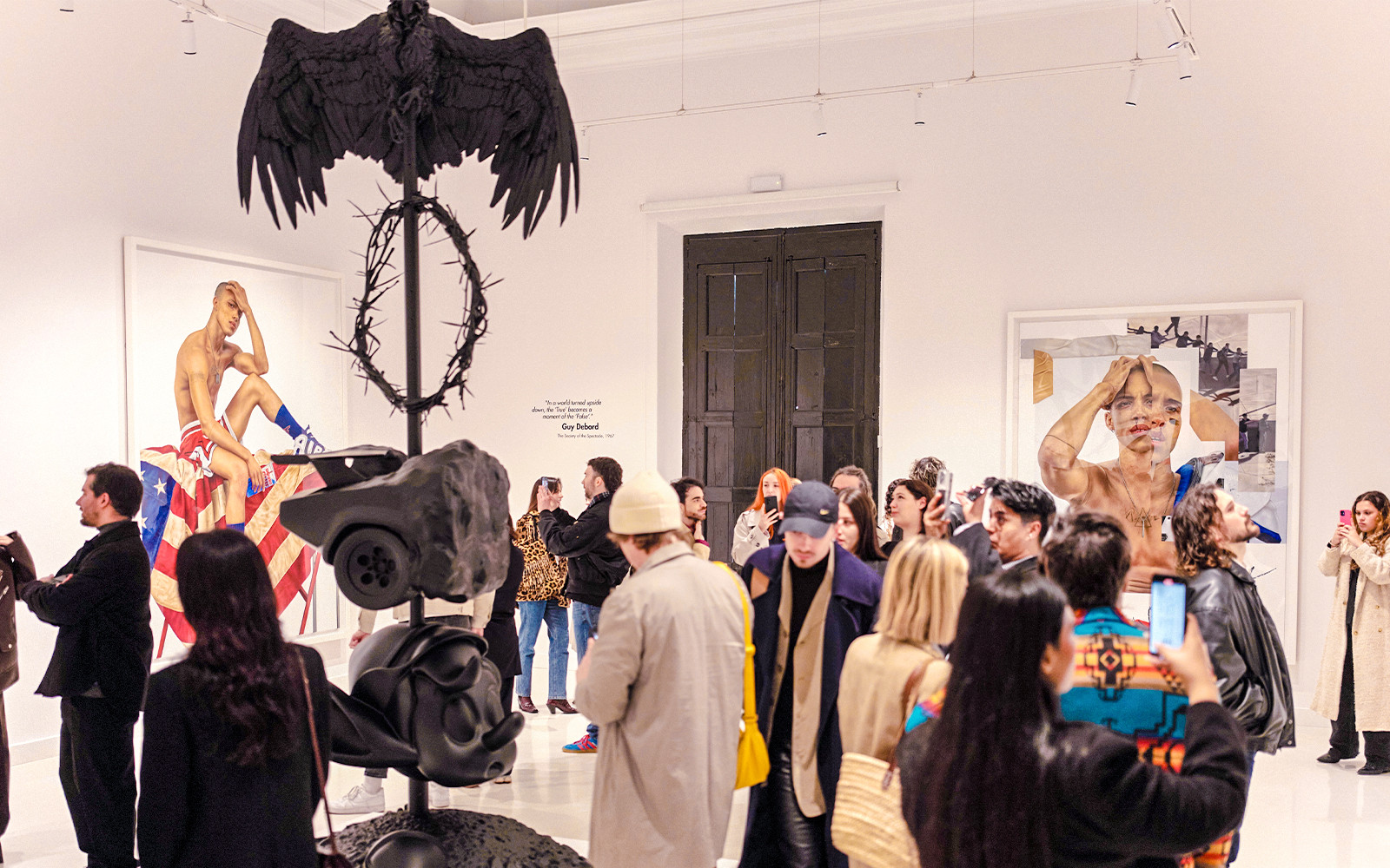 Visitors at Moco Museum Barcelona exhibit viewing contemporary art installations.