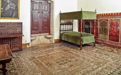 Chamber of D Afonso VI with canopy bed and ornate decor in Sintra National Palace.