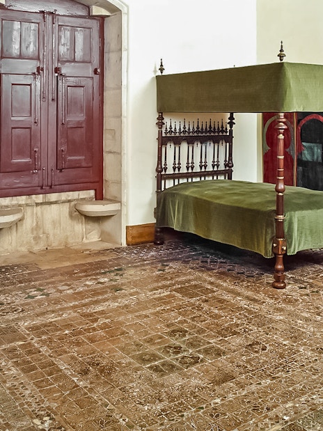 Chamber of D Afonso VI with canopy bed and ornate decor in Sintra National Palace.