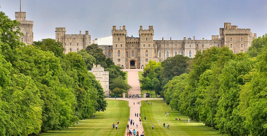 Windsor Castle view with visitors walking along the Long Walk, England.