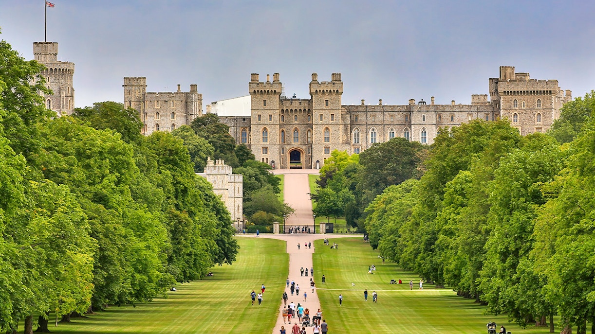Windsor Castle view with visitors walking along the Long Walk, England.