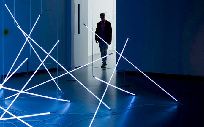 Ellsworth Kelly exhibit with intersecting blue light rods, 1949-2015.