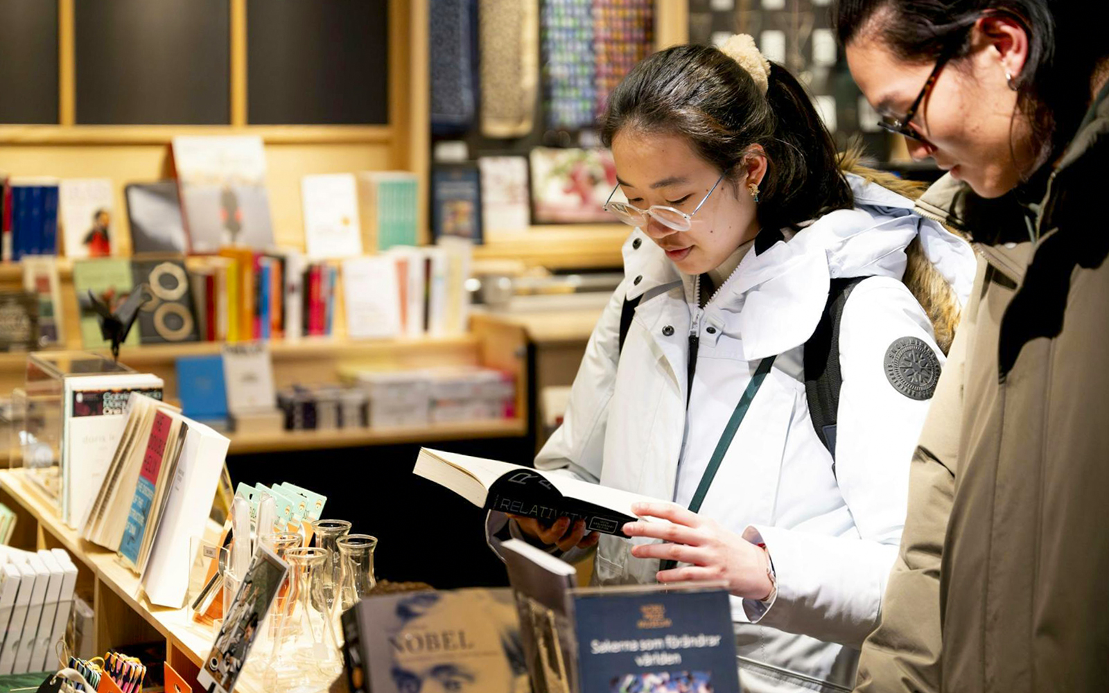 Visitors browsing books at the Nobel Prize Museum shop.