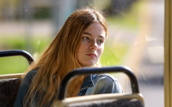 Female guest enjoying scenic views during coach transfer.