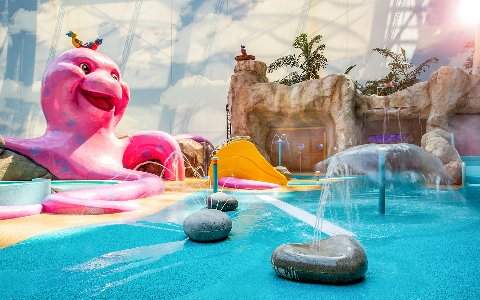 Colorful water play area with slides and fountains at Tropical Islands Resort.