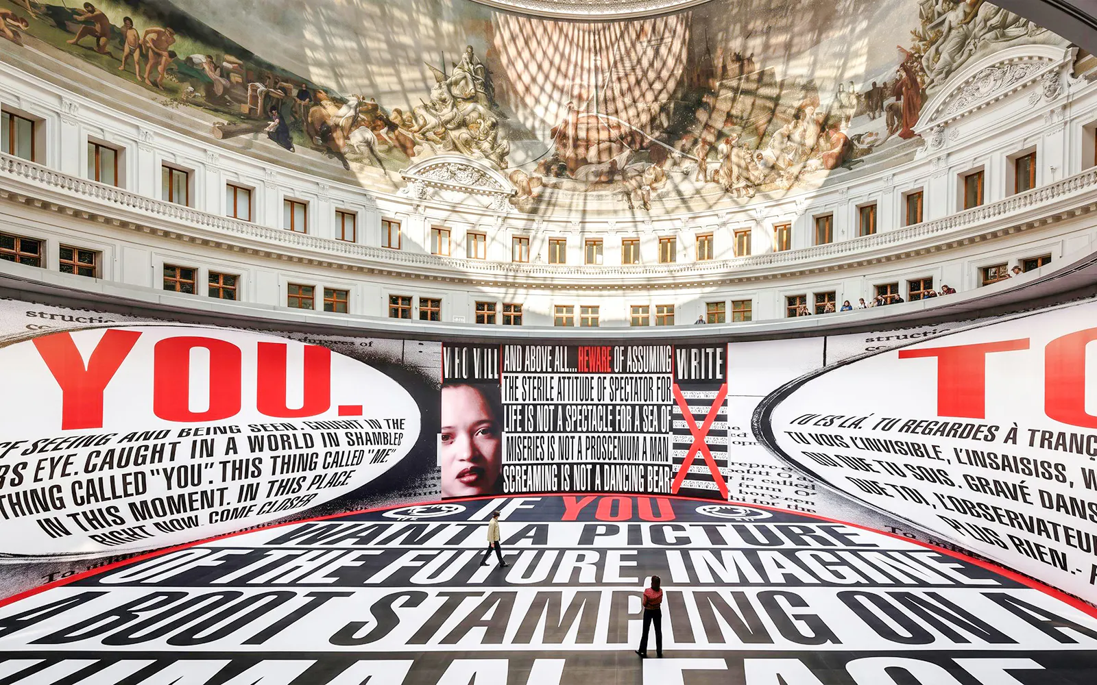 Bourse de Commerce Pinault Collection interior with large text installation and ornate ceiling fresco.