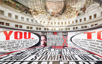 Bourse de Commerce Pinault Collection interior with large text installation and ornate ceiling fresco.