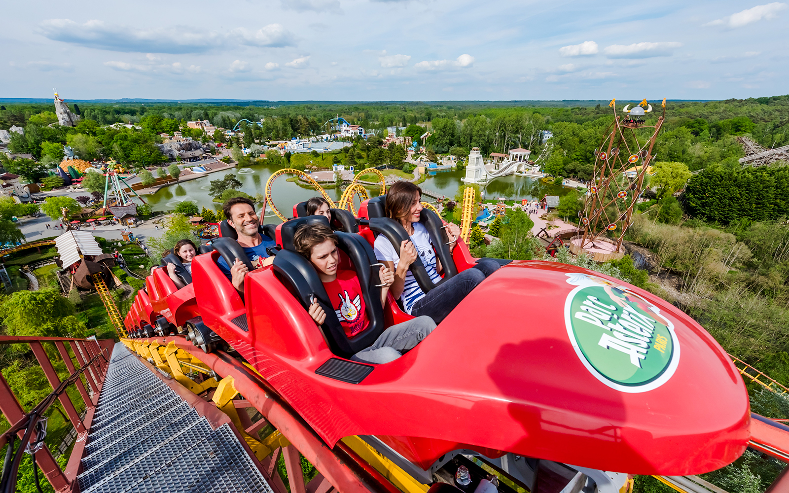 Roller coaster ride at Parc Asterix with scenic park view in the background.