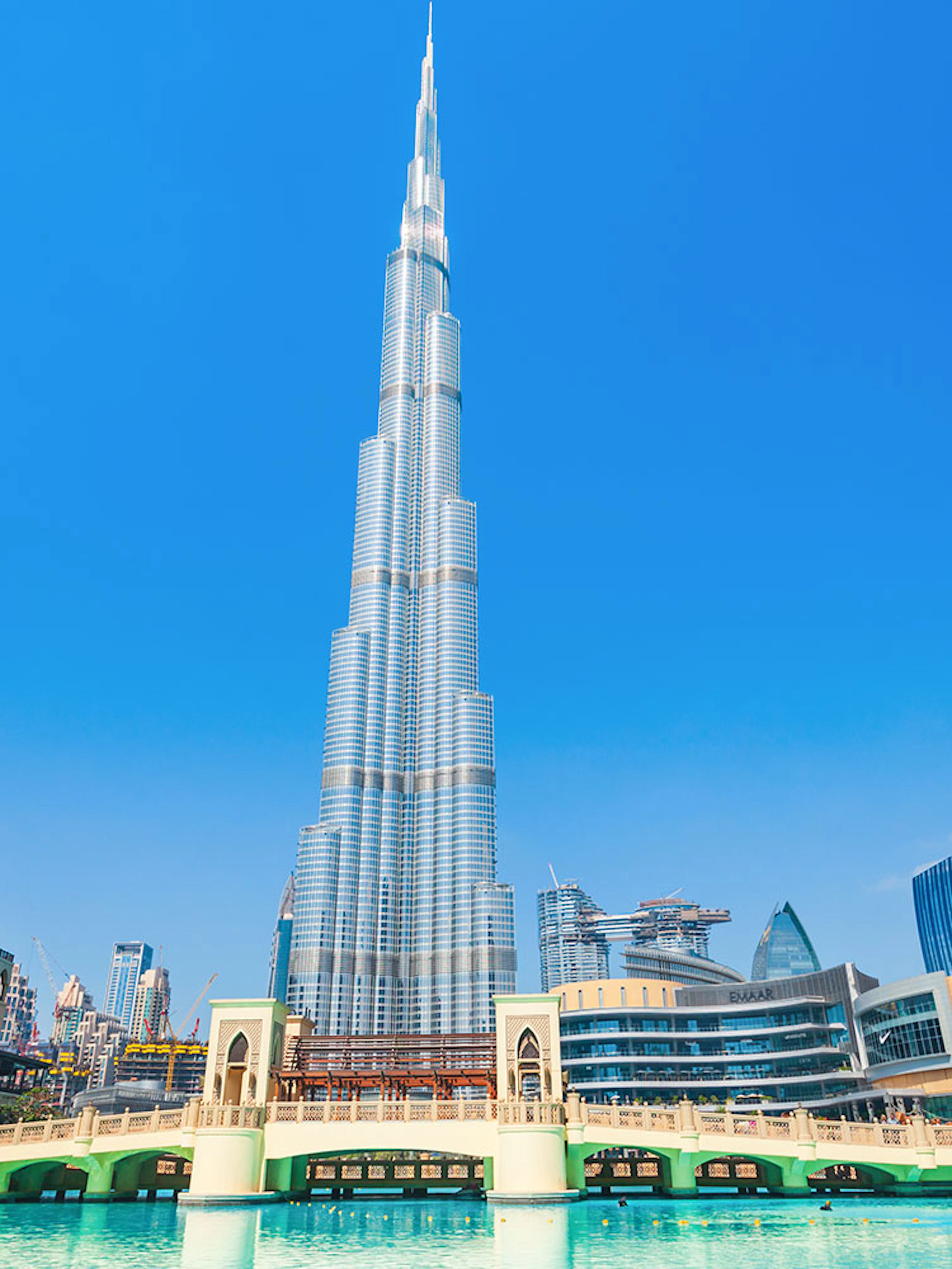 Burj Khalifa and surrounding Dubai skyline on a sunny day during a full day tour.
