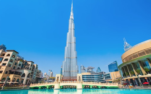 Burj Khalifa and surrounding Dubai skyline on a sunny day during a full day tour.