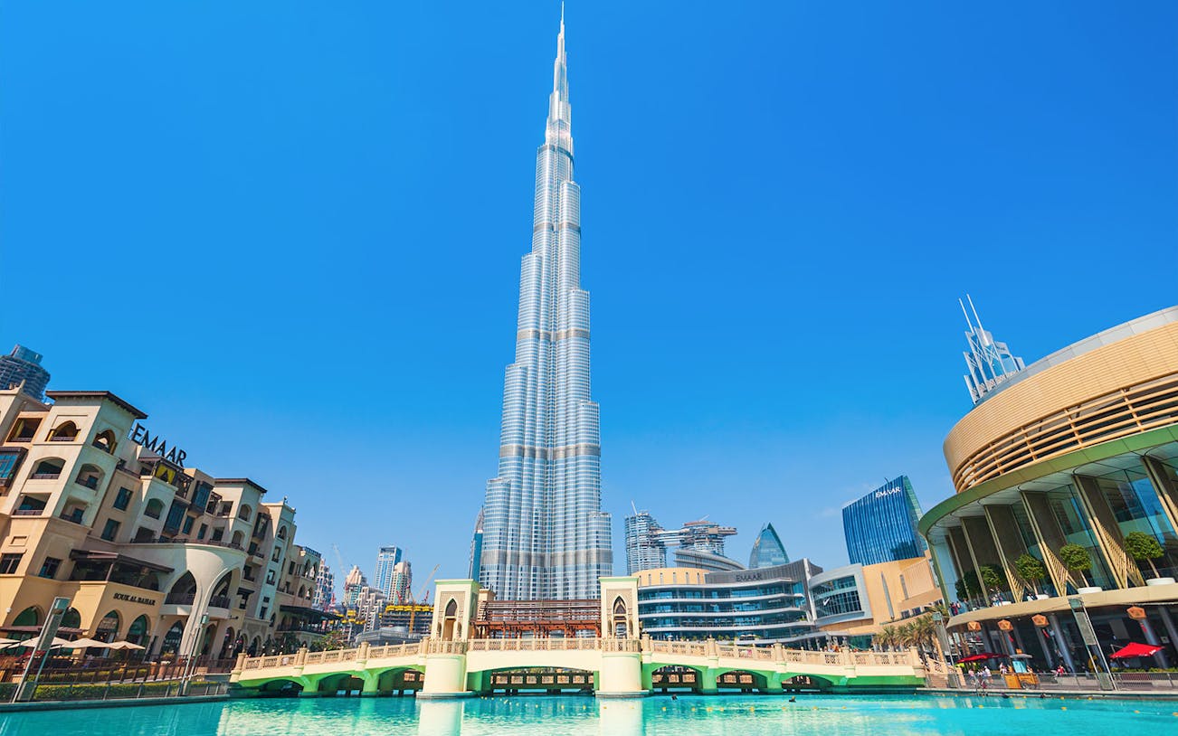 Burj Khalifa and surrounding Dubai skyline on a sunny day during a full day tour.