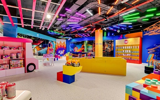 Colorful indoor play area at Mission: Play! by Mattel with toys and interactive exhibits.