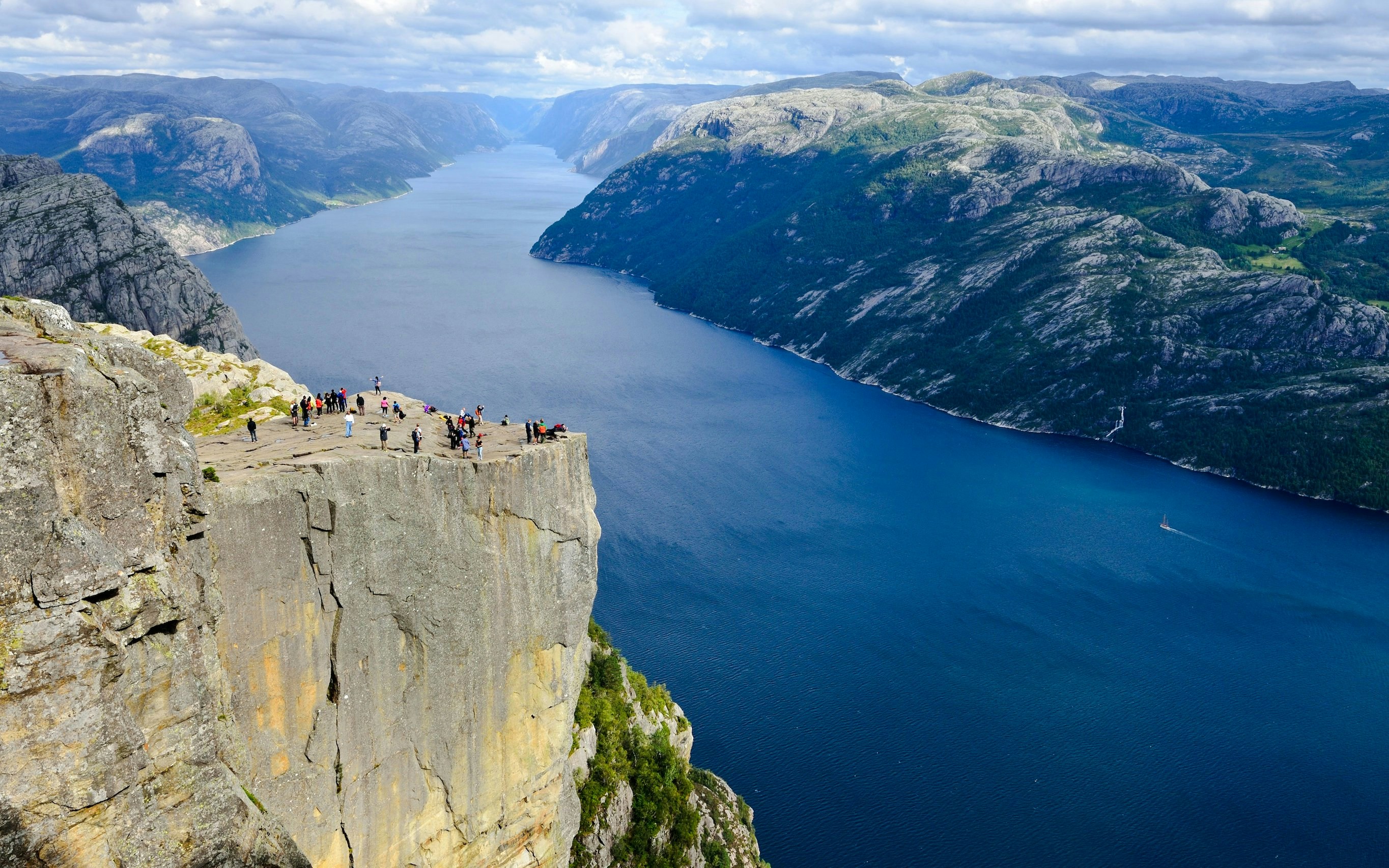 Aerial view of Pulpit Rock with tourists overlooking Lysefjord, Stavanger, Norway.