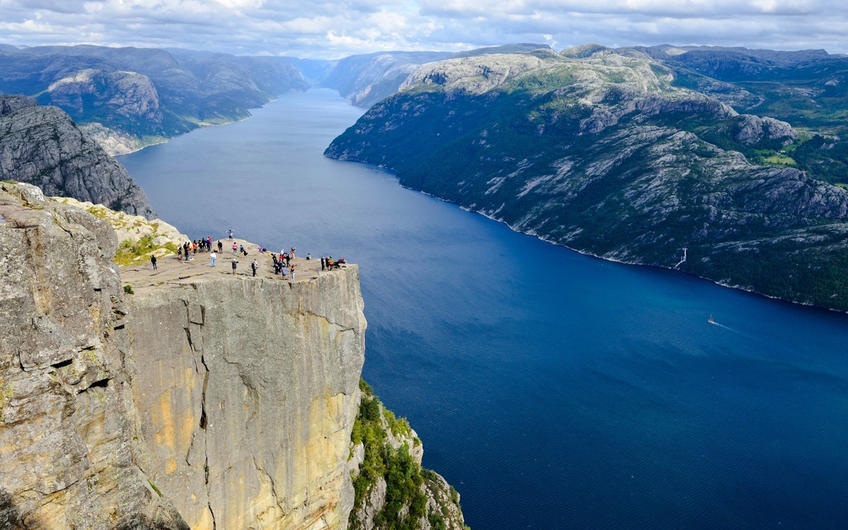 Aerial view of Pulpit Rock with tourists overlooking Lysefjord, Stavanger, Norway.