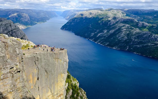 Aerial view of Pulpit Rock with tourists overlooking Lysefjord, Stavanger, Norway.