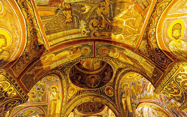 Cappadocia church ceiling with intricate frescoes on a guided day tour.