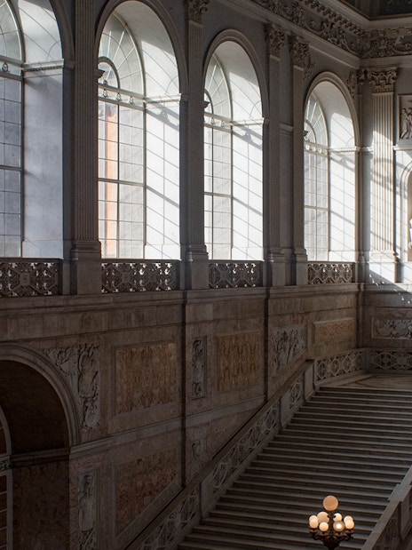 Grand staircase and arched windows inside Museo di Capodimonte, Naples.