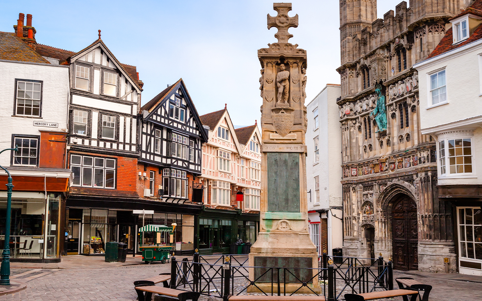 Historic buildings and war memorial in Canterbury town center, England.
