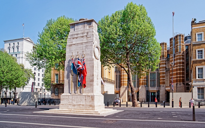 Cenotaph war memorial with flags on Whitehall, London.