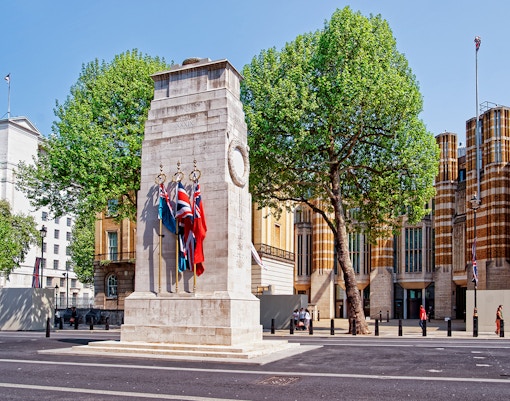Cenotaph war memorial with flags on Whitehall, London.