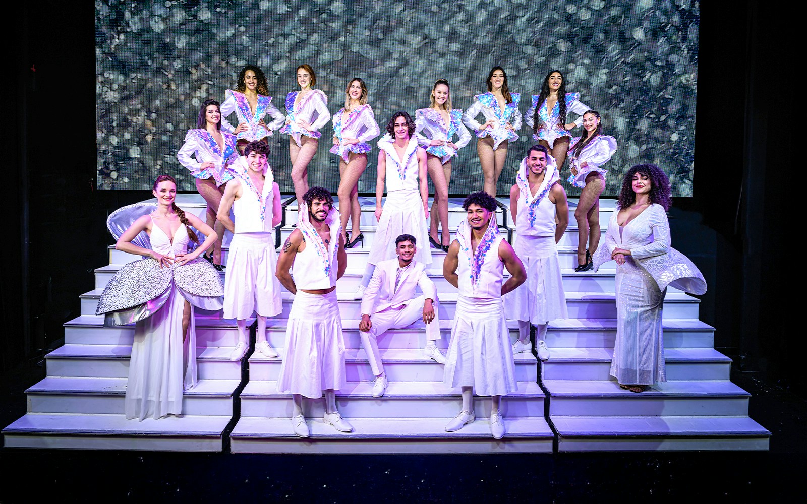 Performers on stage at Paradis Latin, Paris, showcasing vibrant costumes and dynamic choreography.