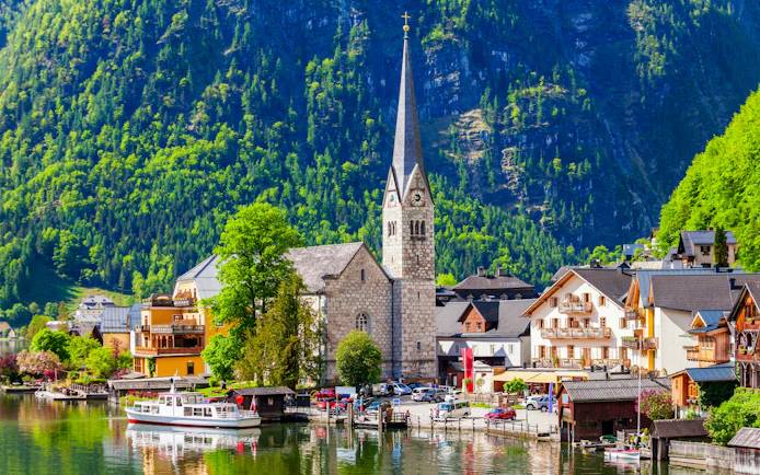 Lutheran Church in Hallstatt with mountains and lake in the background, Vienna tour.