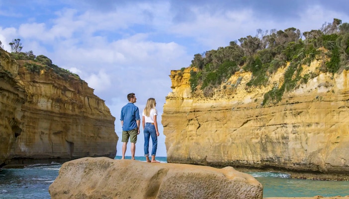 Couple admiring Loch Ard Gorge on Great Ocean Road Sunset Tour, Melbourne.