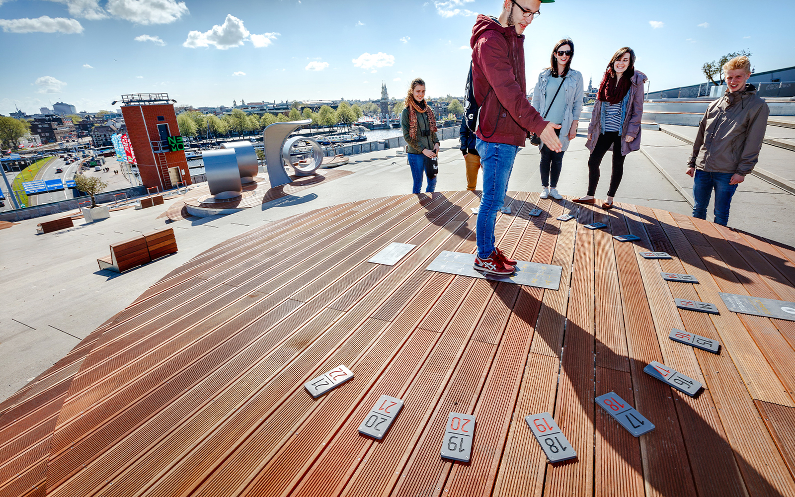 Visitors exploring rooftop exhibit at NEMO Science Museum in Amsterdam.