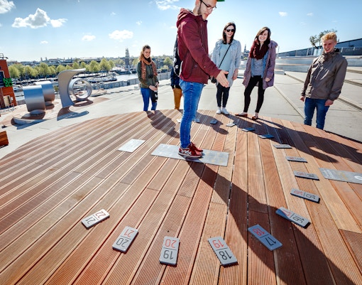 Visitors exploring rooftop exhibit at NEMO Science Museum in Amsterdam.