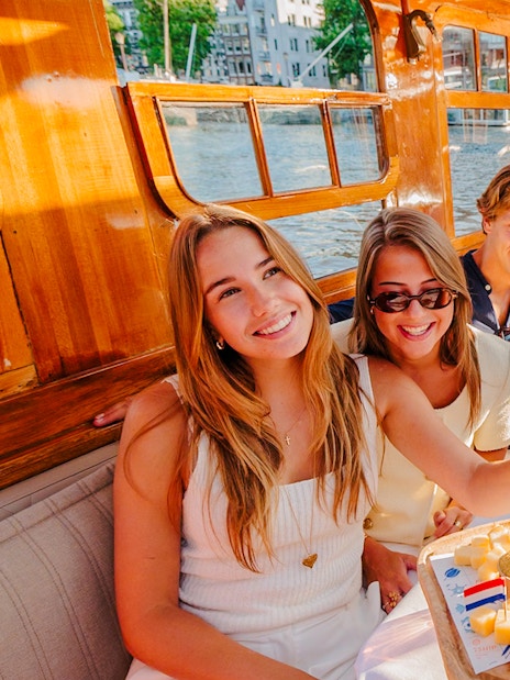 Guests enjoying cheese and wine on a classic Amsterdam cruise.