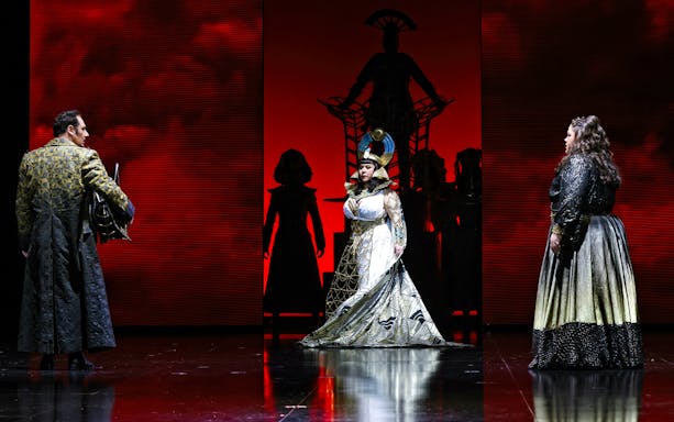 Opera performers in dramatic costumes on stage during Aida at Queensland Performing Arts Centre.