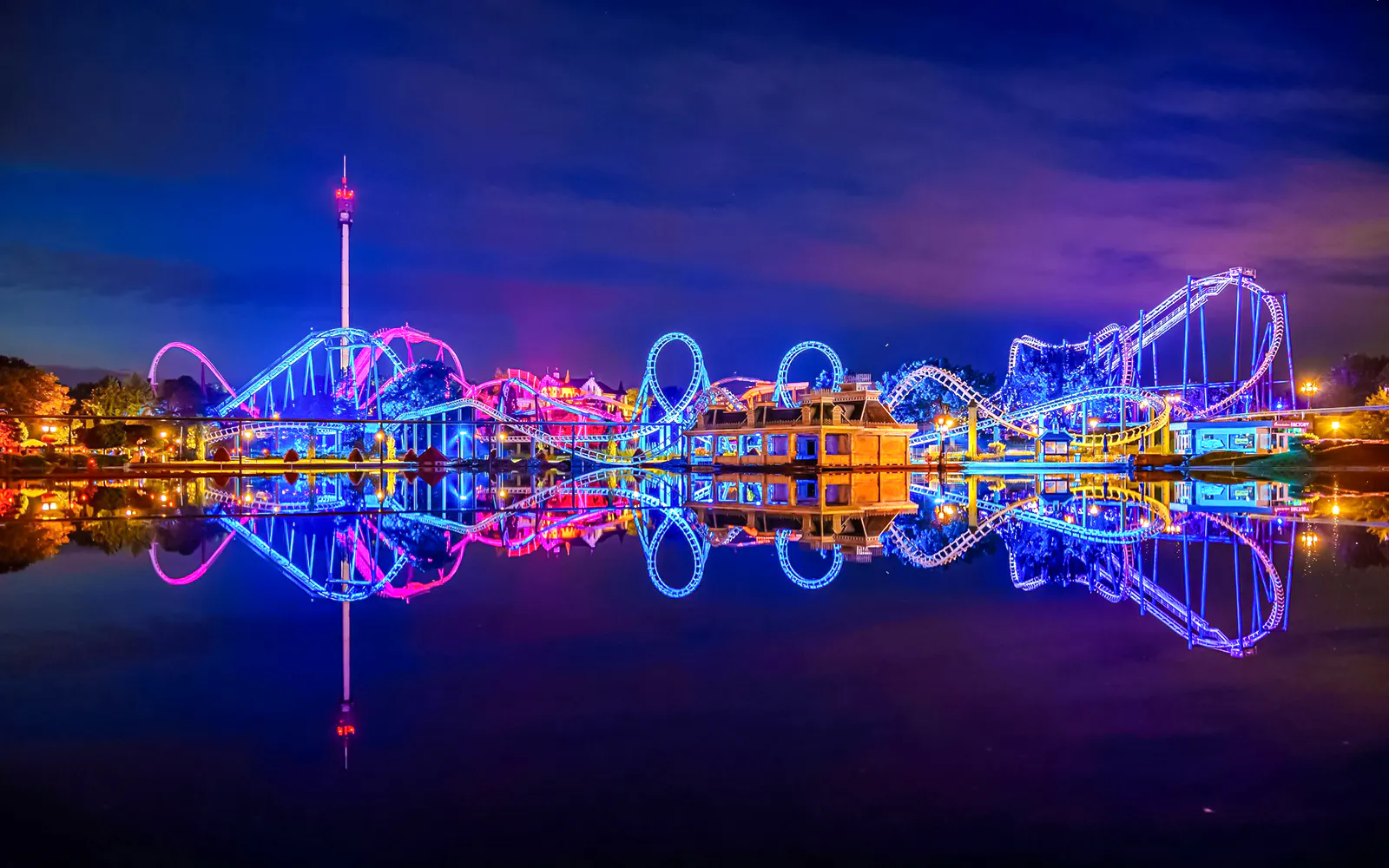 Roller coaster illuminated at night during Halloween at Heide Park, Germany.