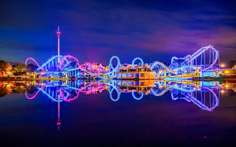Roller coaster illuminated at night during Halloween at Heide Park, Germany.
