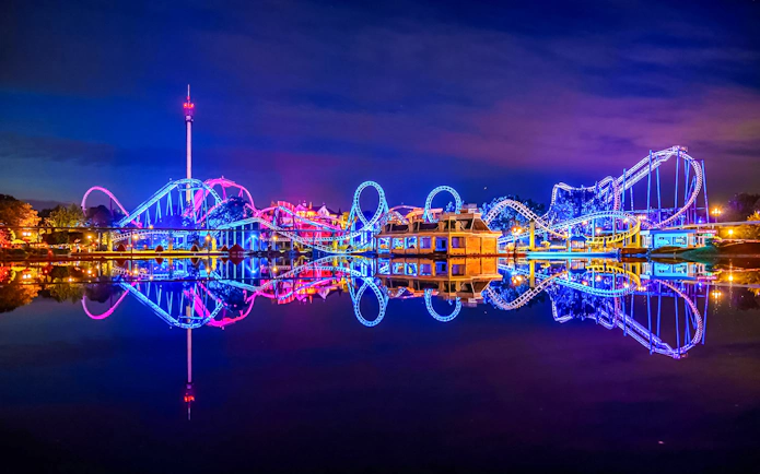Roller coaster illuminated at night during Halloween at Heide Park, Germany.