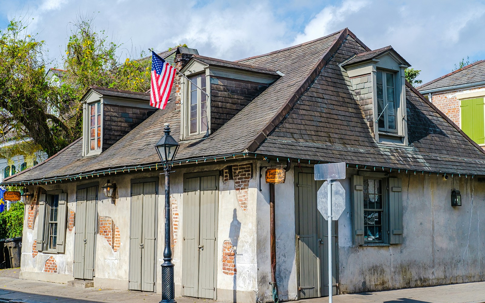Lafitte's Blacksmith Shop with American flag on Bourbon Street, French Quarter, New Orleans.
