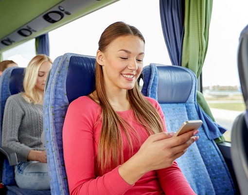 Passengers on a shuttle bus from porto using mobile devices.