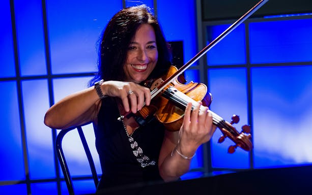 Violinist performing at Great Opera Arias Concert in Rome.