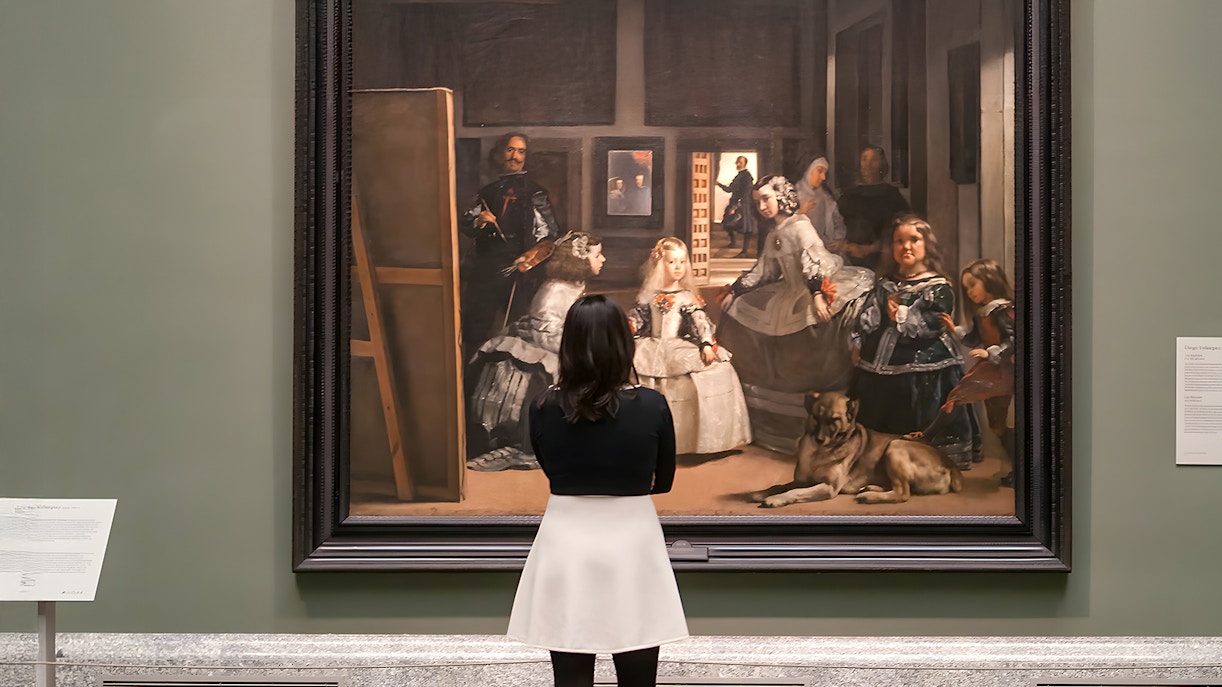Visitors admiring classical art in Prado Museum, Madrid, Spain.