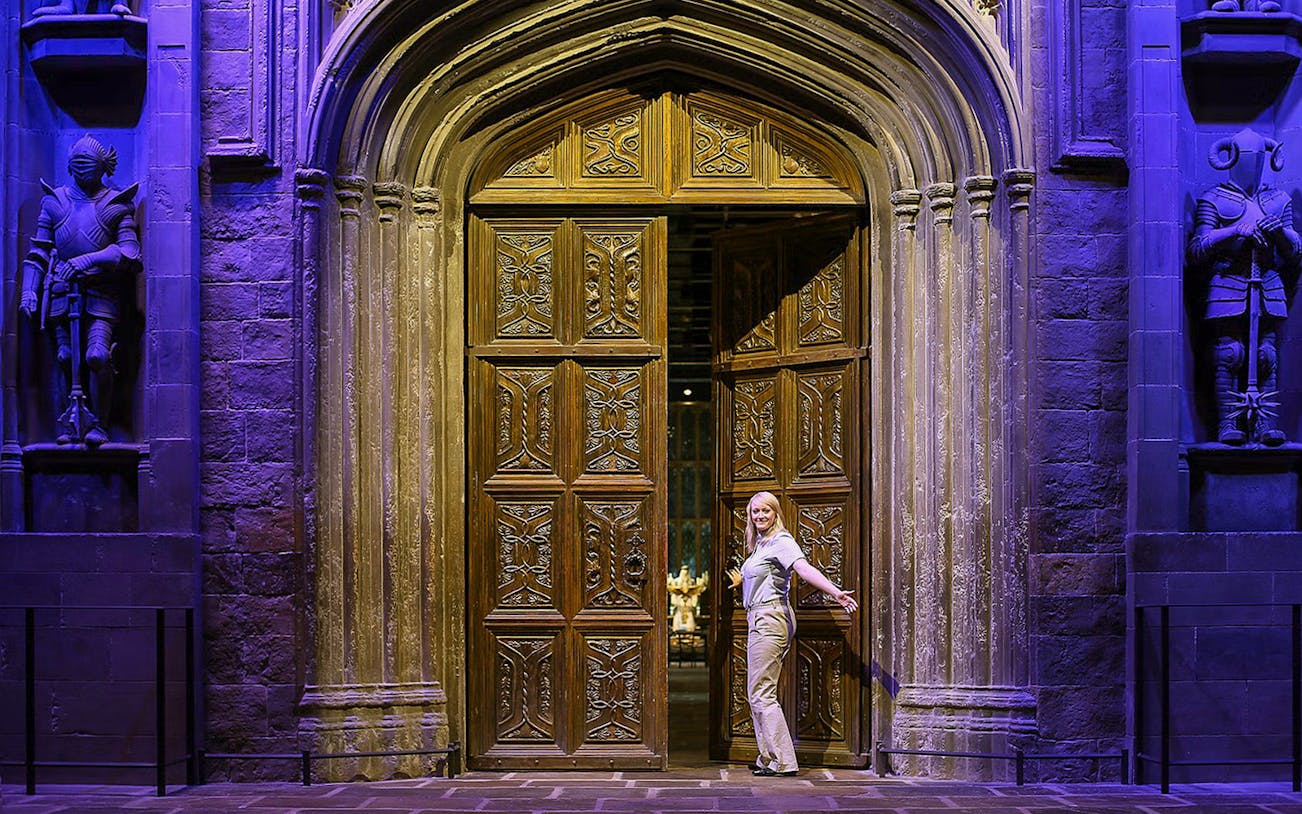 Entrance to the Great Hall with ornate wooden doors and stone statues.