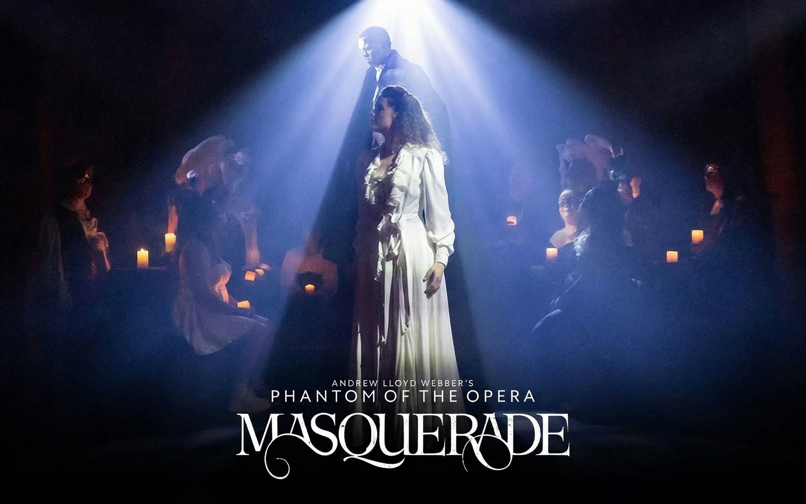 Stage scene from Phantom of the Opera's Masquerade on Broadway, featuring actors in spotlight.