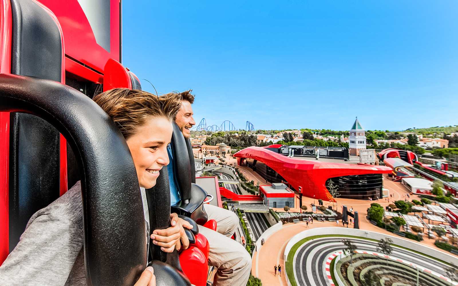 Ferrari Land aerial view from ride, showcasing roller coasters and attractions in PortAventura, Spain.
