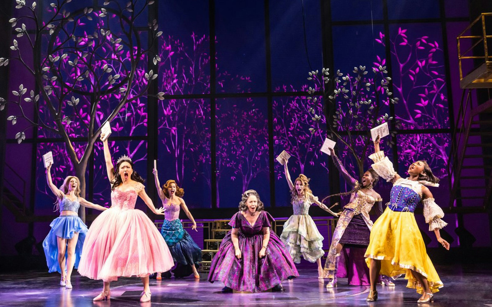 Performers in colorful costumes on stage during "Once Upon a One More Time" musical.