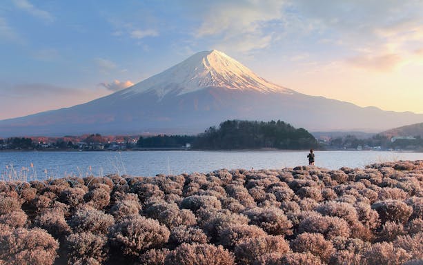 Mt. Fuji view from Kawaguchiko with a person photographing the landscape.