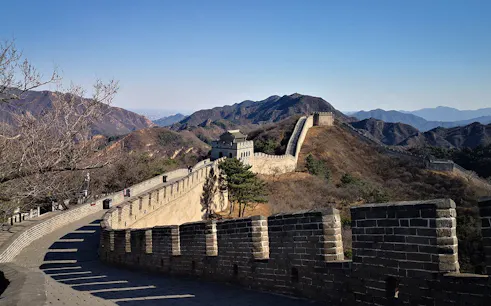 Mutianyu Great Wall section with mountainous backdrop, showcasing ancient stone architecture.