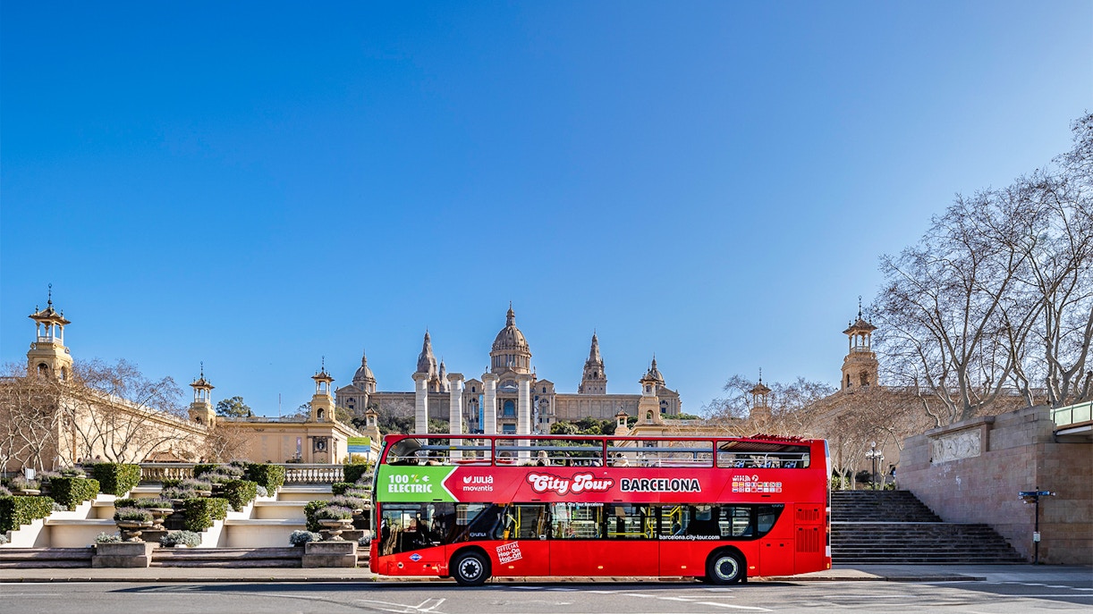 Barcelona hop-on hop-off bus passing Sagrada Familia.